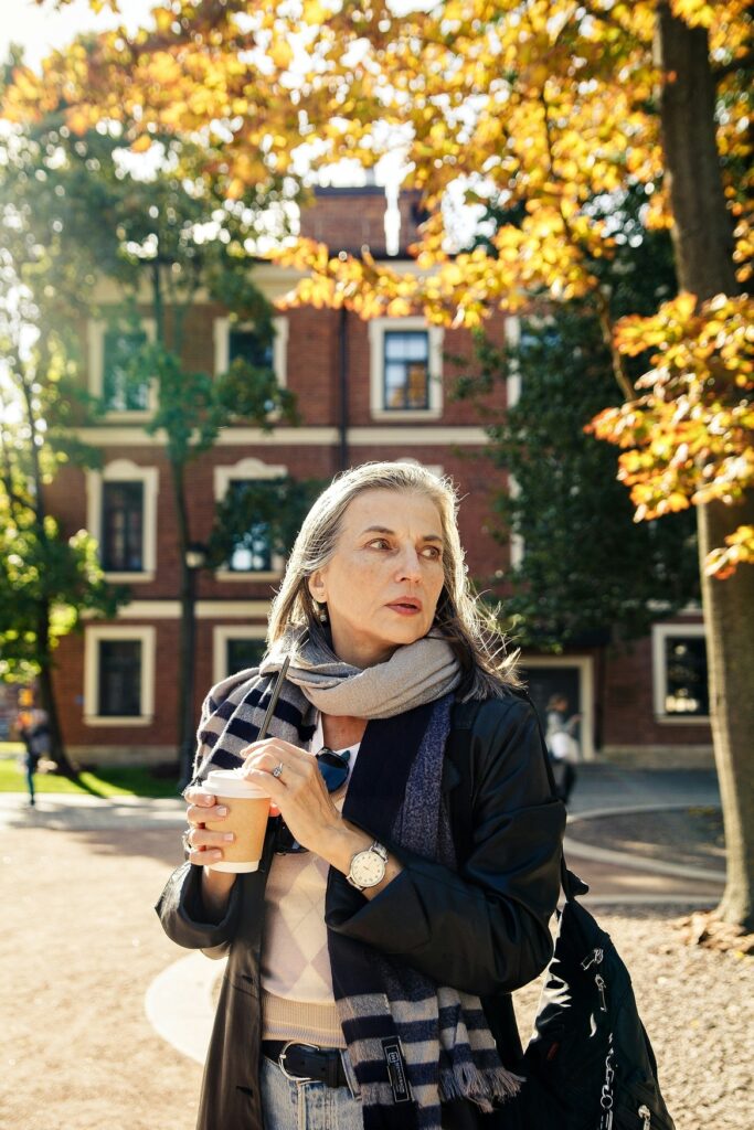 Mature woman over 50 with elegant gray hair holding a warm drink — best collagen supplements for women over 50